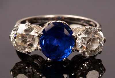 Lot 6 - A sapphire and diamond three-stone ring, the...