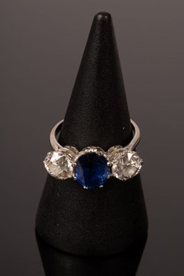 Lot 6 - A sapphire and diamond three-stone ring, the...