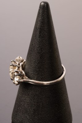 Lot 8 - A diamond three-stone ring, the claw set...