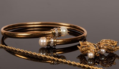 Lot 11 - A 10k gold bangle with cultured pearl...