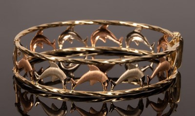 Lot 19 - An Italian bi-colour 14k gold bangle with...