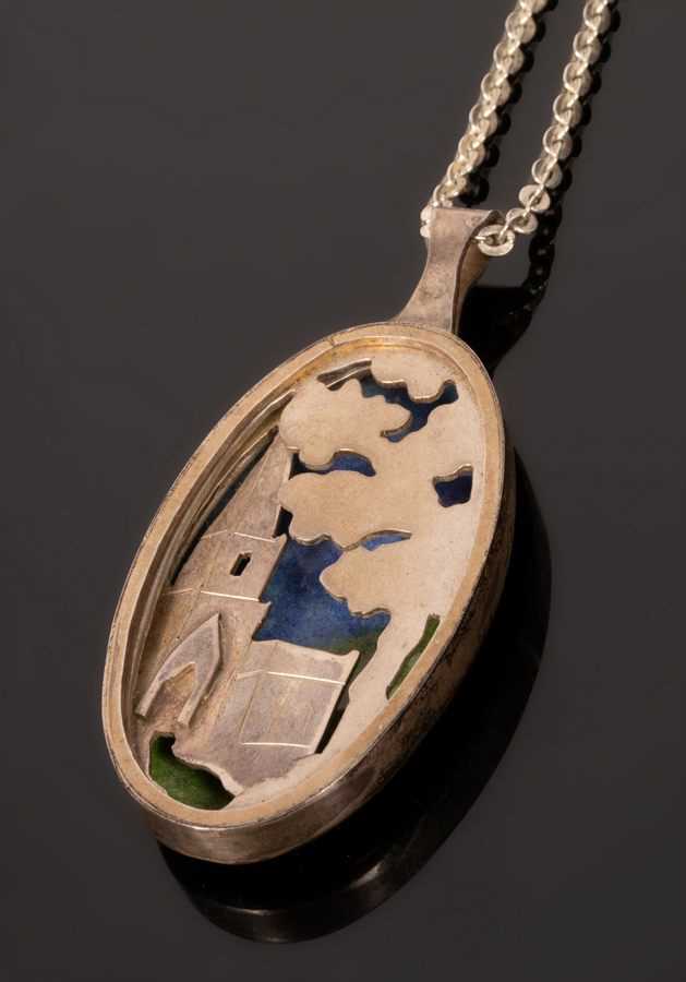 Lot 31 - A silver and enamel oval pendant, EAW, London...