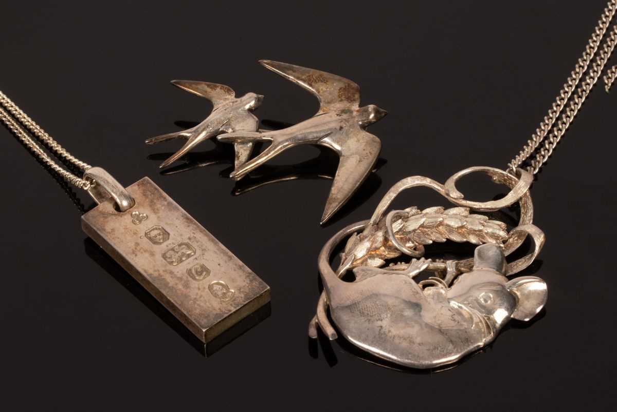 Lot 32 - A silver pendant modelled as a mouse clinging...