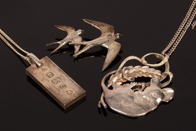 Lot 32 - A silver pendant modelled as a mouse clinging...