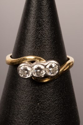 Lot 37 - A diamond three-stone ring in an 18ct yellow...