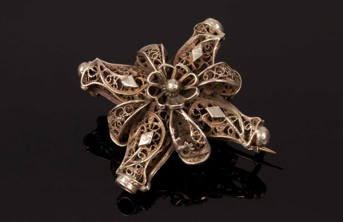 Lot 39 - An Eastern white metal brooch of cross form,...