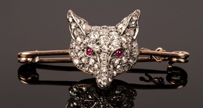 Lot 43 - A diamond and ruby set fox mask stock pin, the...