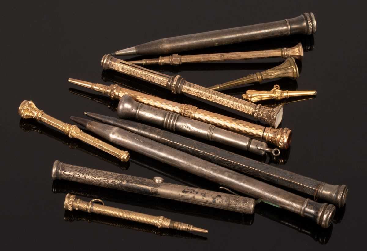 Lot 100 - A silver mounted propelling pencil and nine...