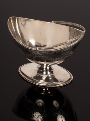 Lot 150 - A George III swing handled silver sugar basket,...