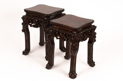 Lot 258 - A pair of Chinese hardwood stands, the tops...