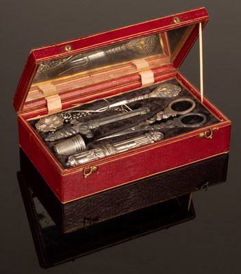 Lot 328 - A sewing kit in a red leather case with gilt...