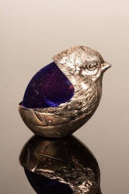 Lot 392 - A silver coloured metal chick pin cushion, 5cm...