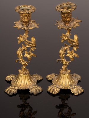 Lot 478 - A pair of gilt metal candlesticks with foliate...