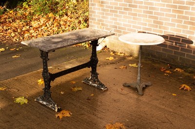 Lot 603 - A rectangular slate top table with cast iron...