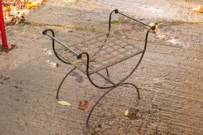 Lot 604 - A wrought iron garden seat with interwoven...