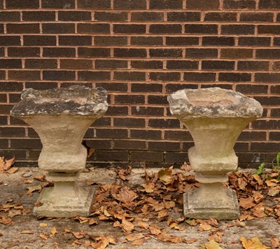 Lot 605 - A pair of weathered stone garden vases, square...