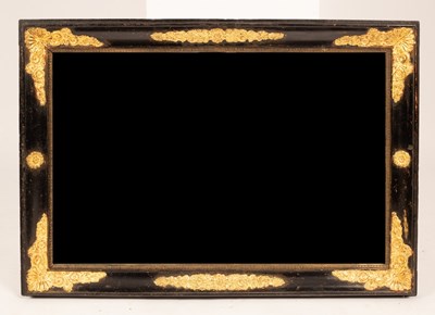 Lot 644 - An ebonised wall mirror with gilded floral...