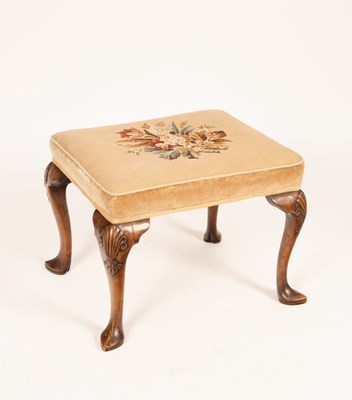 Lot 672 - A walnut stool with upholstered floral...