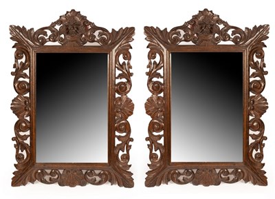 Lot 683 - A pair of oak framed wall mirrors with carved...