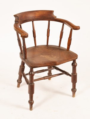 Lot 838 - A Victorian elbow chair with dished elm...