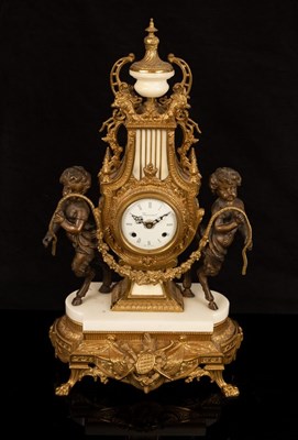 Lot 881 - A modern gilt metal cased mantel clock of lyre...