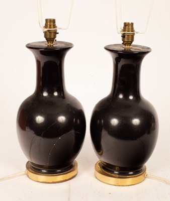 Lot 890 - A pair of ebonised vase-shaped table lights...