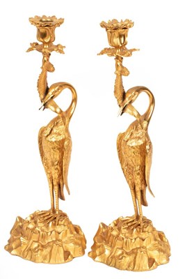 Lot 980 - A pair of figured ormolu candlesticks, each...