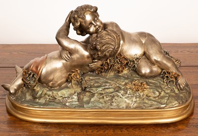 Lot 994 - A patinated metal sculpture of embracing putti,...