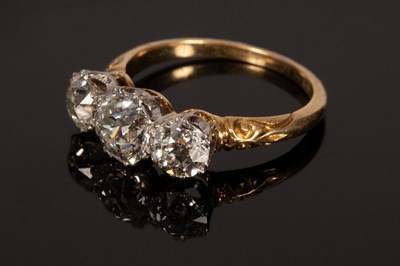 Lot 4 - A diamond three-stone ring, the central stone...