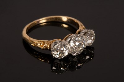 Lot 4 - A diamond three-stone ring, the central stone...