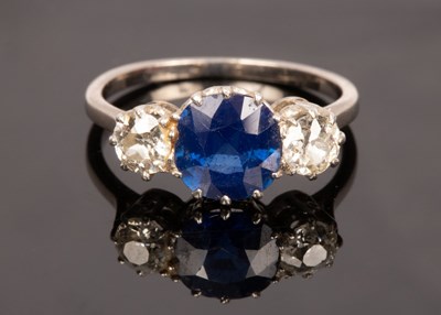 Lot 16 - A sapphire and diamond three stone ring, the...