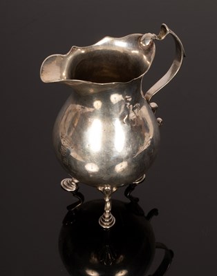 Lot 82 - A Georgian silver jug, marks rubbed, the...