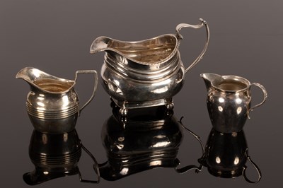 Lot 99 - A Georgian silver jug, marks rubbed, on ball...