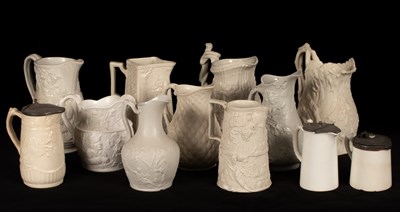 Lot 193 - Twelve saltware jugs, various patterns, three...