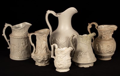 Lot 195 - Six saltware jugs, decorated figures in relief,...