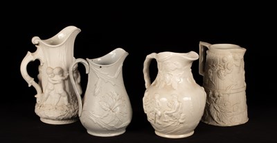 Lot 197 - Four saltware jugs, decorated figures in...