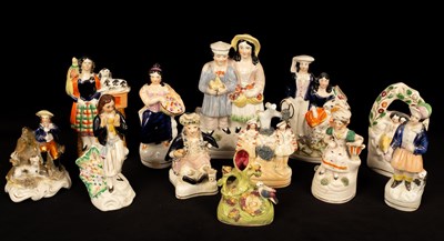 Lot 253 - A collection of Staffordshire figures...