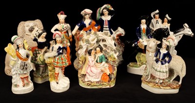 Lot 255 - A collection of Staffordshire figures,...