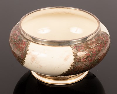 Lot 291 - A ceramic bowl with a silver rim, decorated...