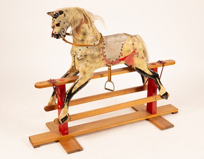 Lot 381 - A dapple-grey rocking horse on an American...