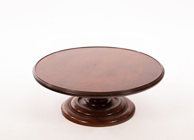 Lot 395 - A 19th Century mahogany lazy Susan on a turned...