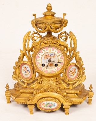 Lot 434 - A gilt metal mounted mantel clock, with urn...