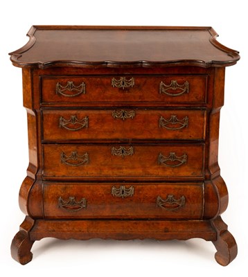 Lot 630 - A Dutch walnut bombé front chest of four...