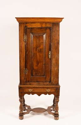 Lot 634 - An early 19th Century oak cupboard on a single...