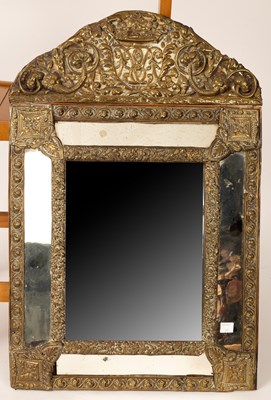 Lot 641 - An Italian embossed brass mirror, monogrammed,...