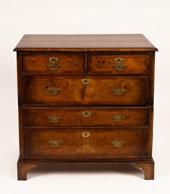 Lot 660 - A walnut chest of three long and two short...