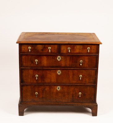 Lot 662 - An early 18th Century walnut chest of three...