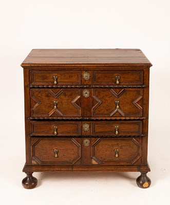 Lot 664 - A Jacobean oak chest of three drawers on bun...