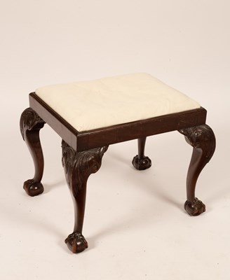 Lot 673 - A rectangular stool on carved legs with ball...