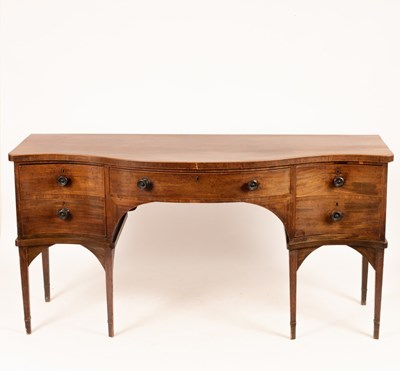 Lot 682 - A George III mahogany serpentine sideboard...